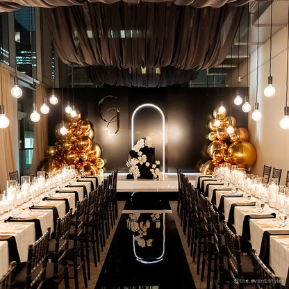 Black gold anniversary dinner event backdrop elegant venue decor