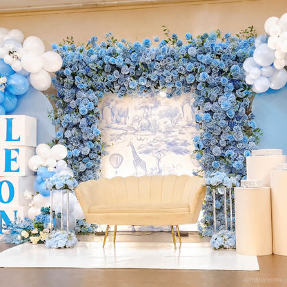 Blue flower wall framing a cream sofa at a celebration