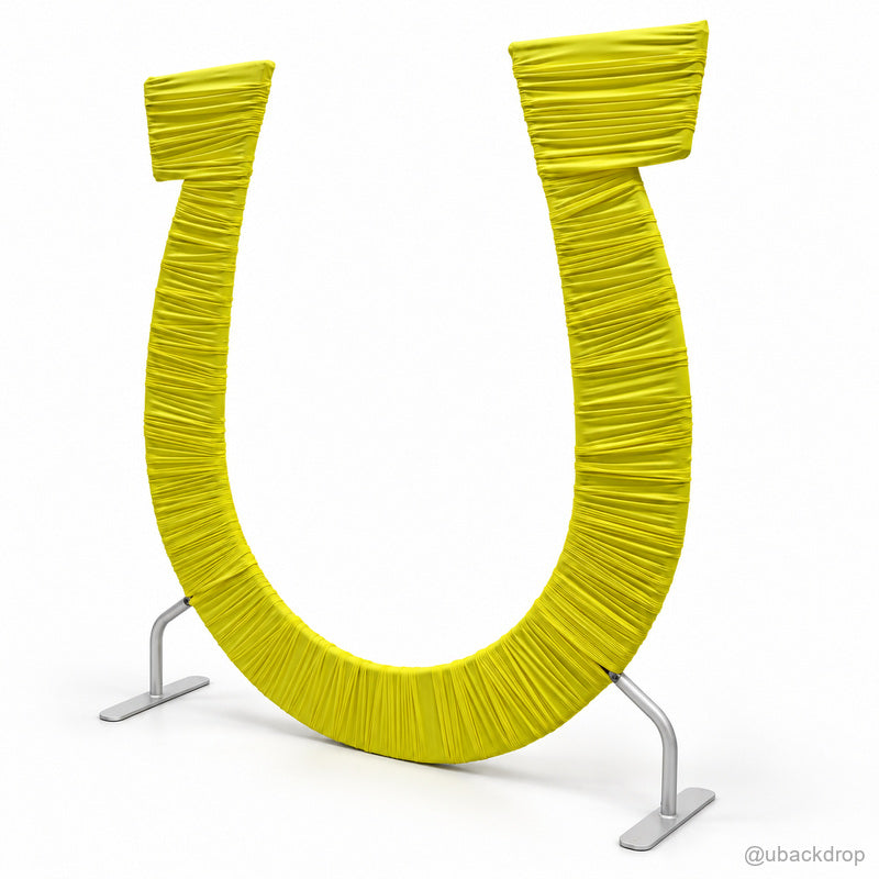 Bright yellow ruched fabric u shaped event backdrop arch angled view