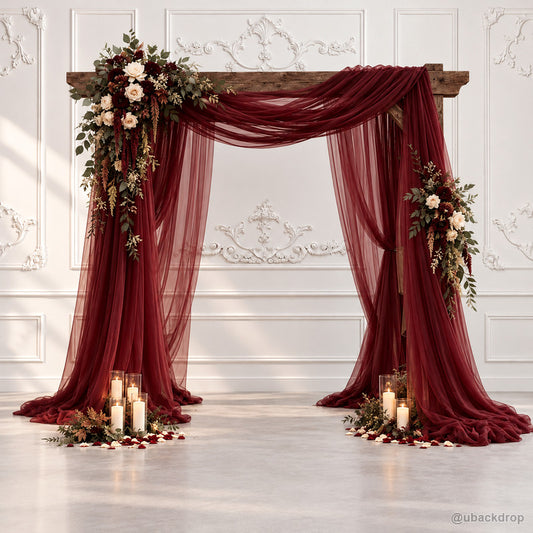 Burgundy sheer draped arch with floral wedding backdrop