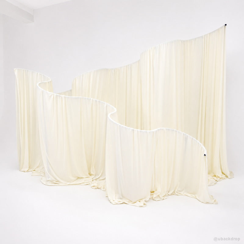 Cream curved drapery wall party stand event photo backdrop