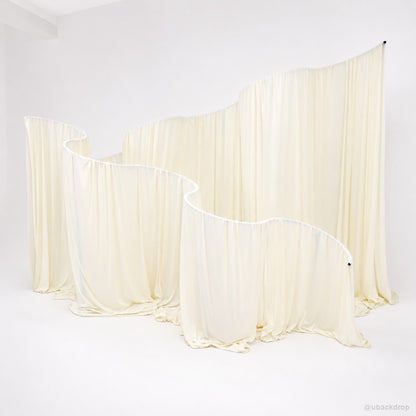 Cream curved drapery wall party stand event photo backdrop