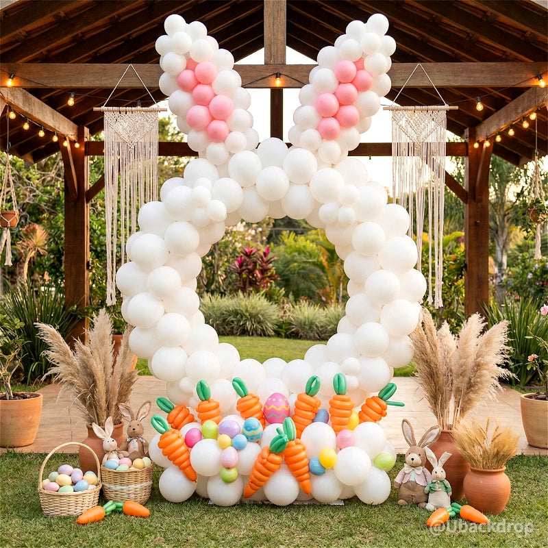 White balloon hoop arch shaped like a bunny with pink ears, carrot balloons, and Easter eggs. Ideal party photo booth backdrop.