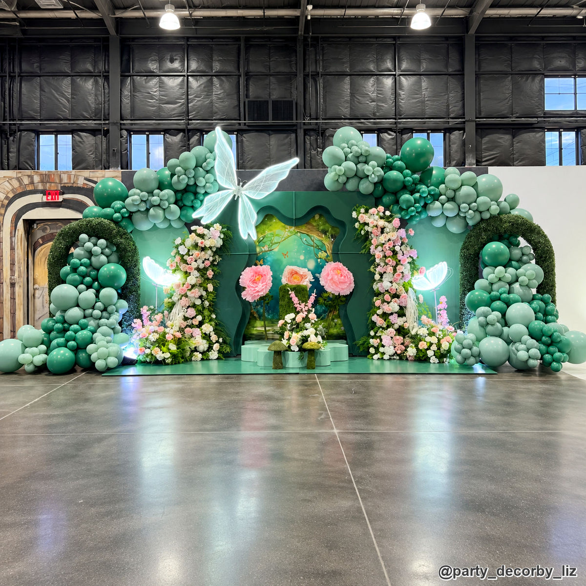 Emerald green butterfly floral balloon backdrop garden party event installation
