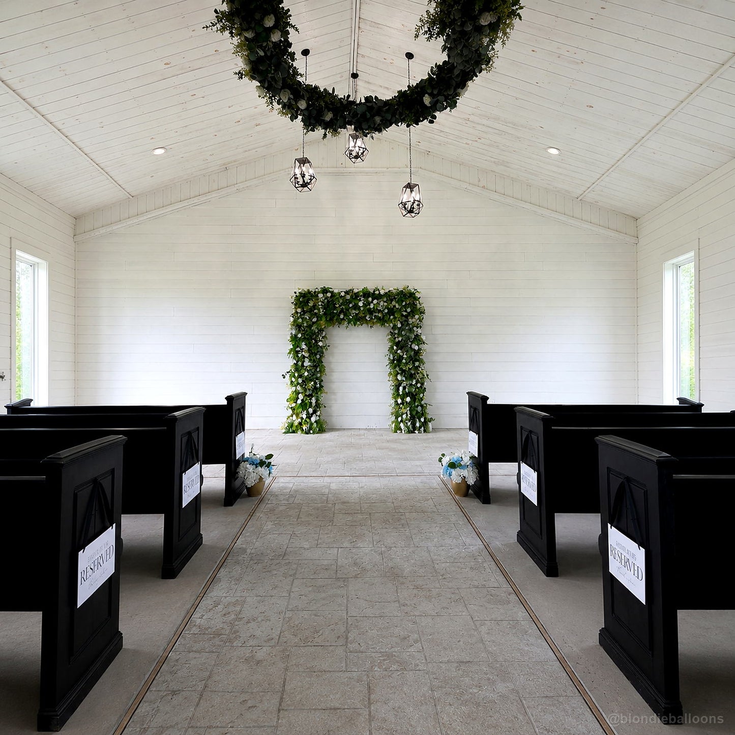 Green floral ceremony arch white chapel wedding aisle backdrop