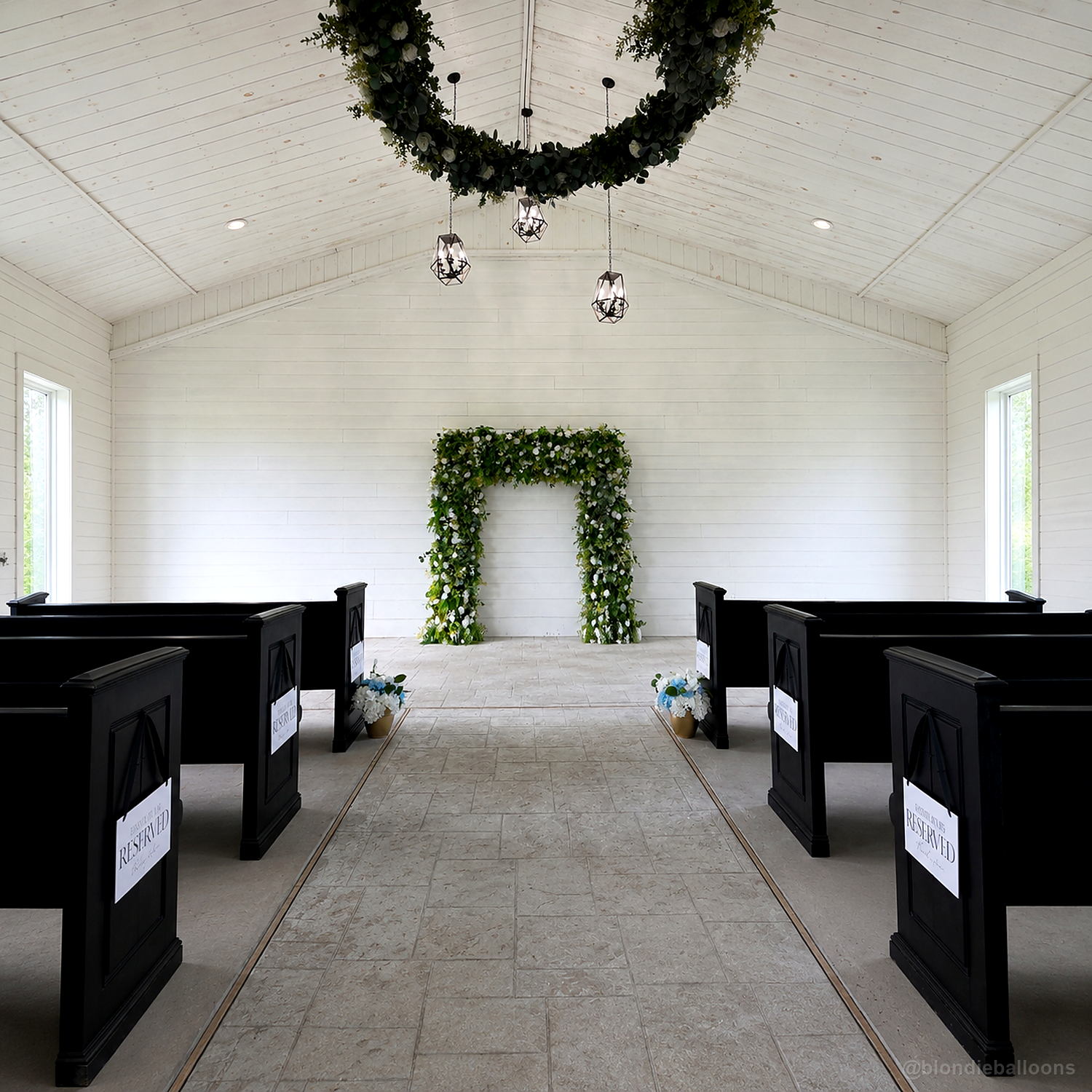 Green floral ceremony arch white chapel wedding aisle backdrop