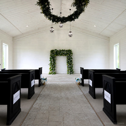 Green floral ceremony arch white chapel wedding aisle backdrop