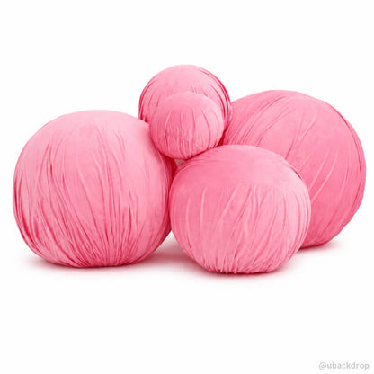 Group of pink velvet fabric inflatable balls on white background