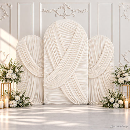 Ivory crossed pleated fabric triple arch wedding backdrop