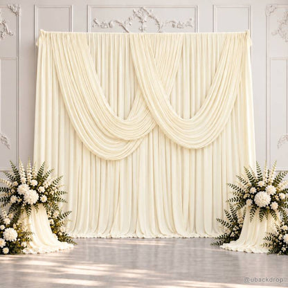 Ivory double swag wedding drape backdrop with white floral arrangements 10x10ft