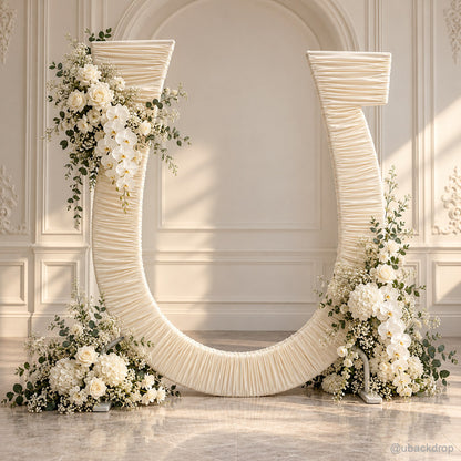 Ivory ruched u shaped wedding arch with white flowers and greenery