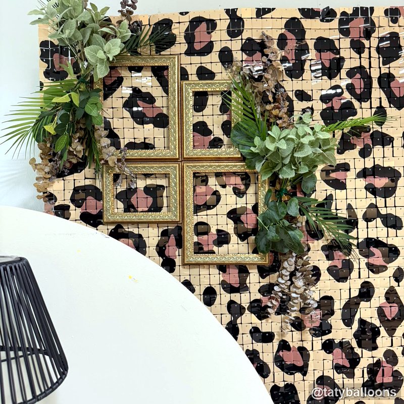 Leopard shimmer wall greenery detail modern party backdrop