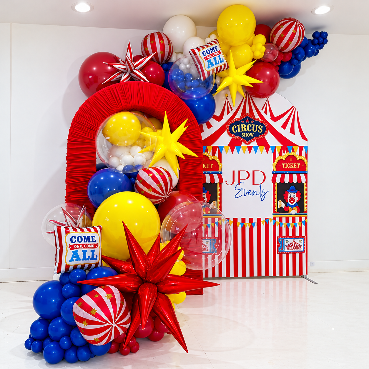 Circus birthday decor with red ruched arch and printed Chiara backdrop