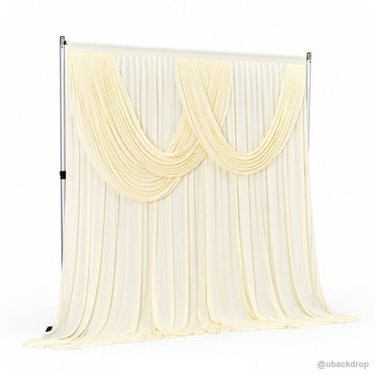 Pale yellow double swag draped backdrop left angle view
