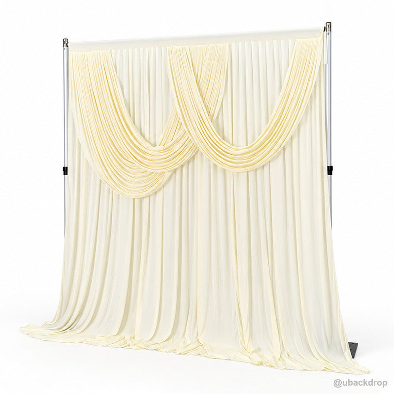 Pale yellow double swag draped backdrop right angle view