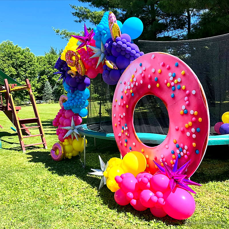 Pink donut balloon garland outdoor birthday party backdrop display
