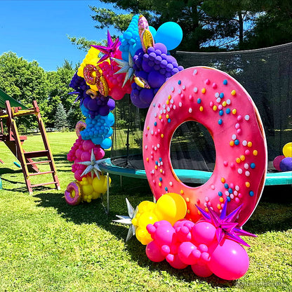 Pink donut balloon garland outdoor birthday party backdrop display