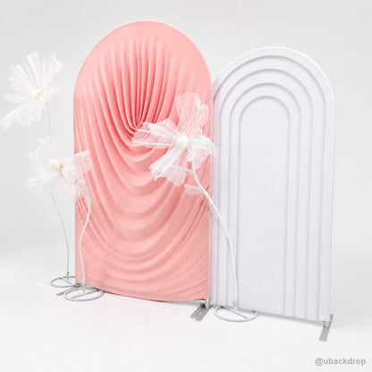 Pink ruched fabric arch white frame floral event backdrop