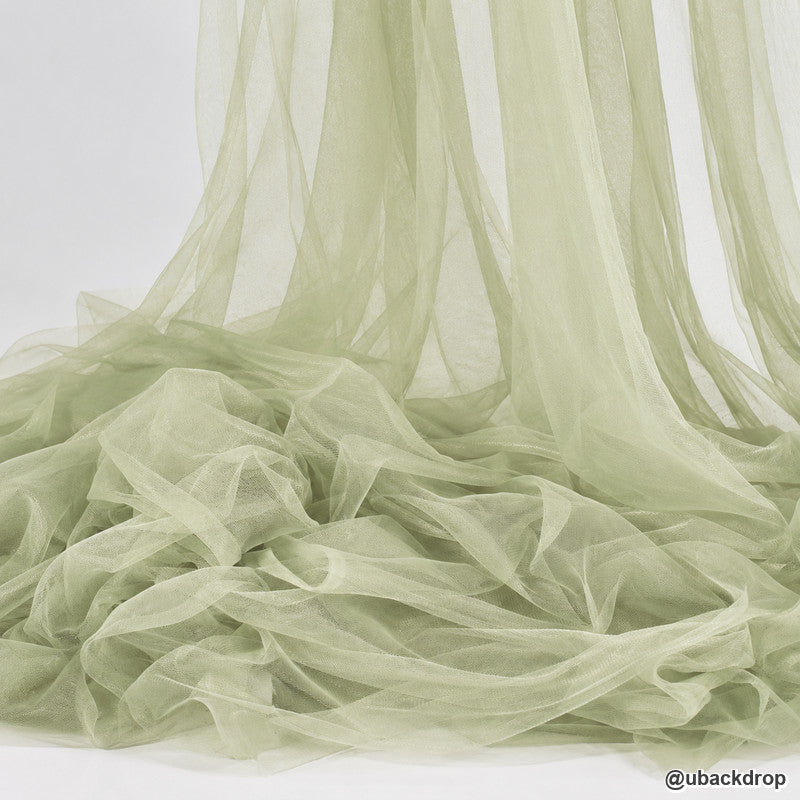 Sage green sheer tulle fabric wedding backdrop texture draped event decor