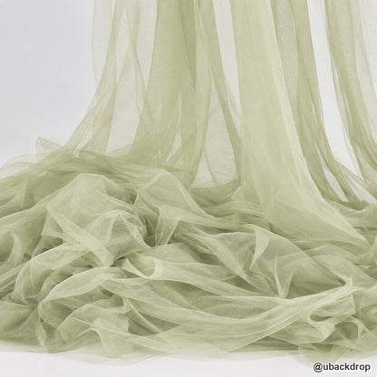 Sage green sheer tulle fabric wedding backdrop texture draped event decor
