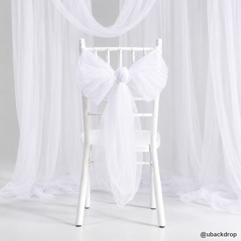 White chair draped tulle bow wedding backdrop ceremony event seat decoration