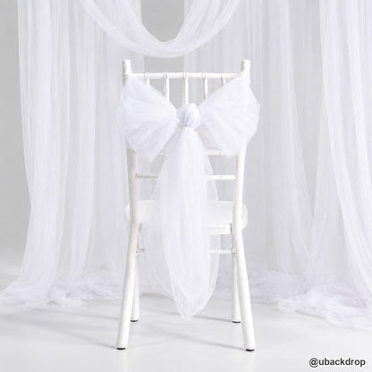 White chair draped tulle bow wedding backdrop ceremony event seat decoration