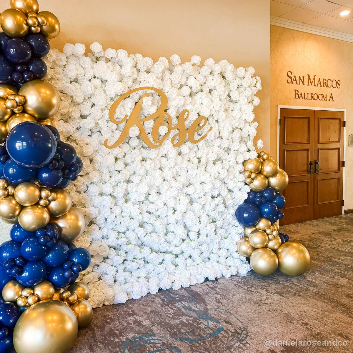 White rose flower wall blue gold balloon garland event backdrop